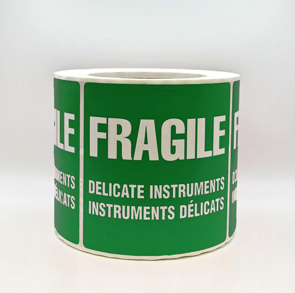 A green label with white text that reads 'FRAGILE DELICATE INSTRUMENTS' in both English and French. Side view