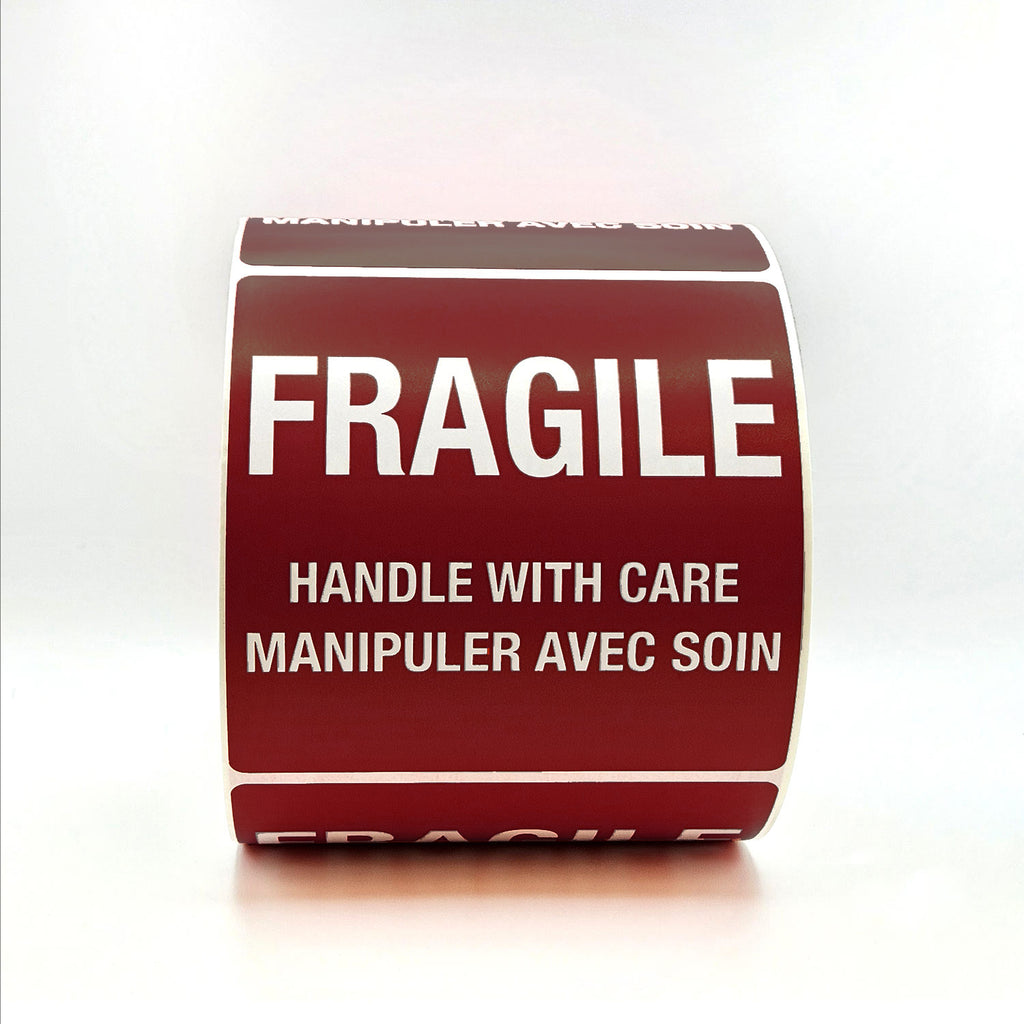 Roll of burgundy labels with 'Fragile Handle with Care' text on a white background