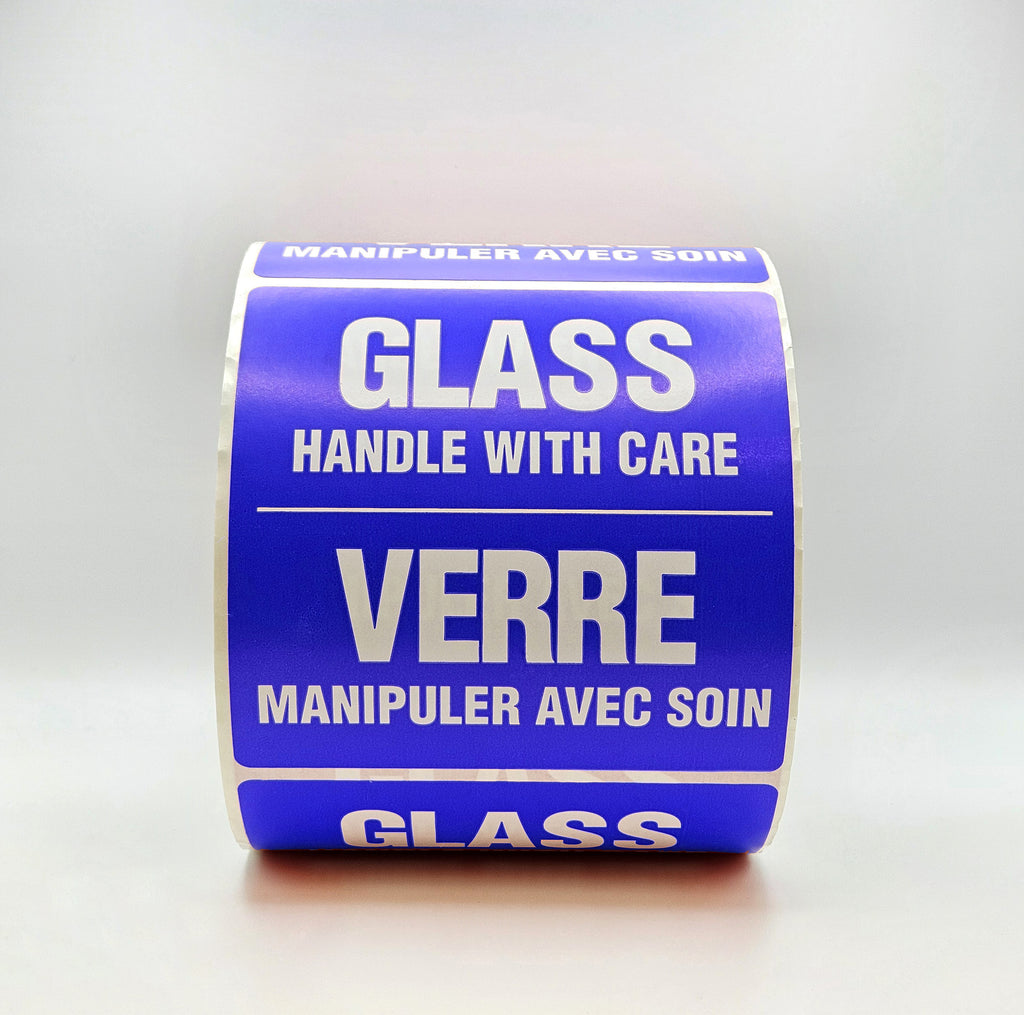 Roll of blue labels with white text warning 'Handle with care' and 'Glass'.