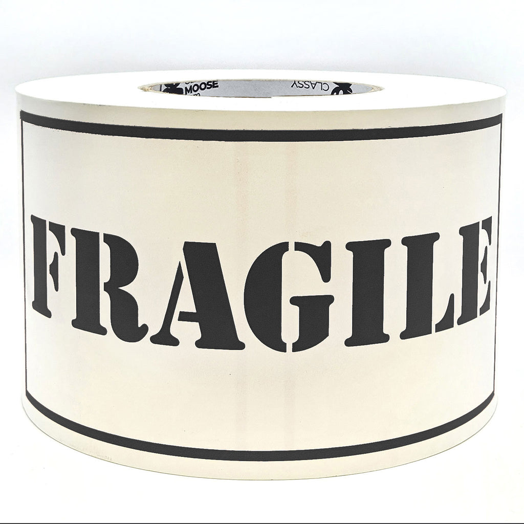 A roll of 'Fragile' sticker labels with the word 'Fragile' printed in black on a white background with borders.