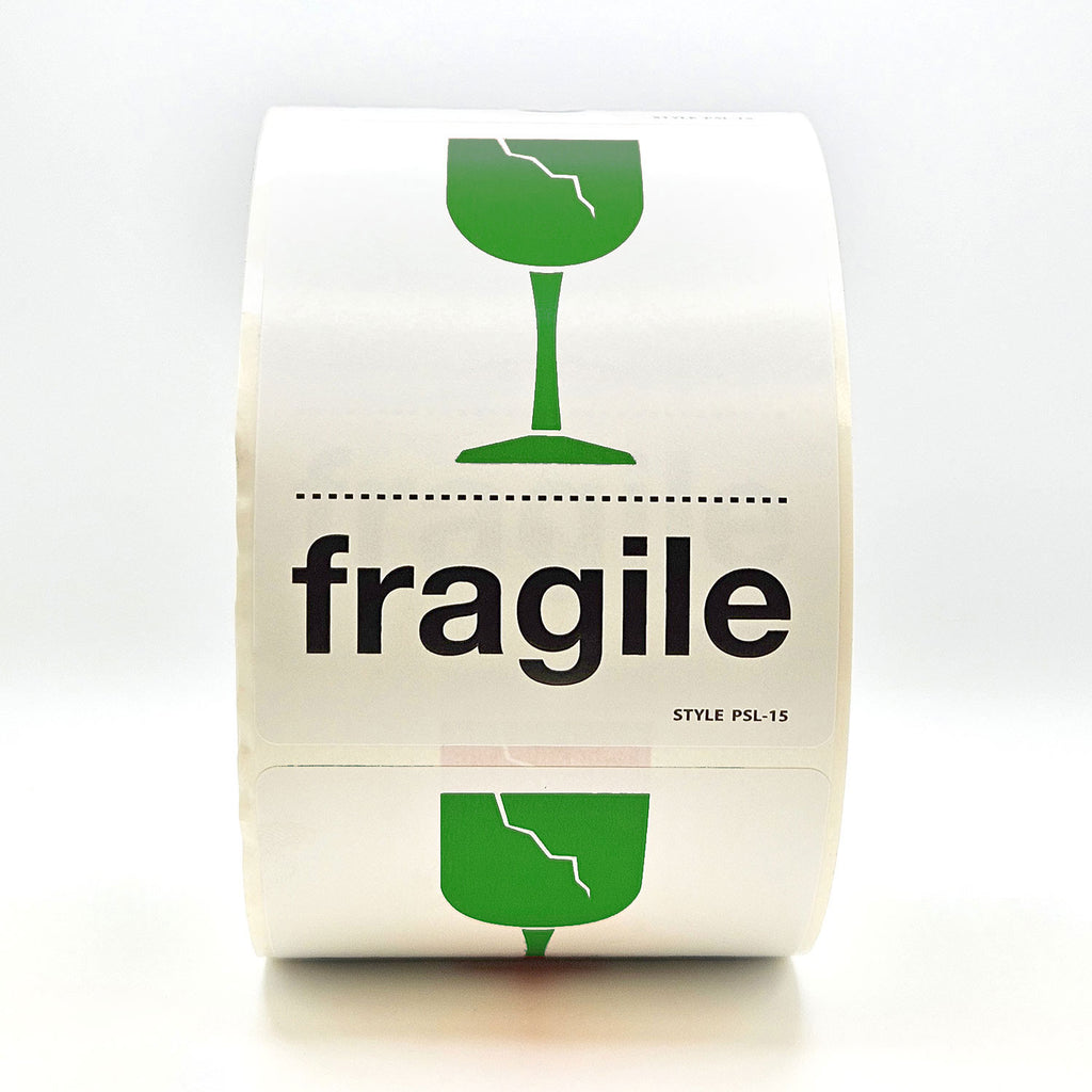 A roll of white labels with 'fragile' text and a broken glass pictogram in green and black.