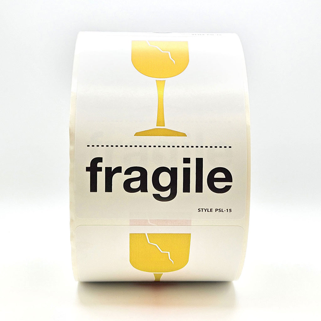 A roll of white labels with 'fragile' text and a broken glass pictogram in yellow and black.