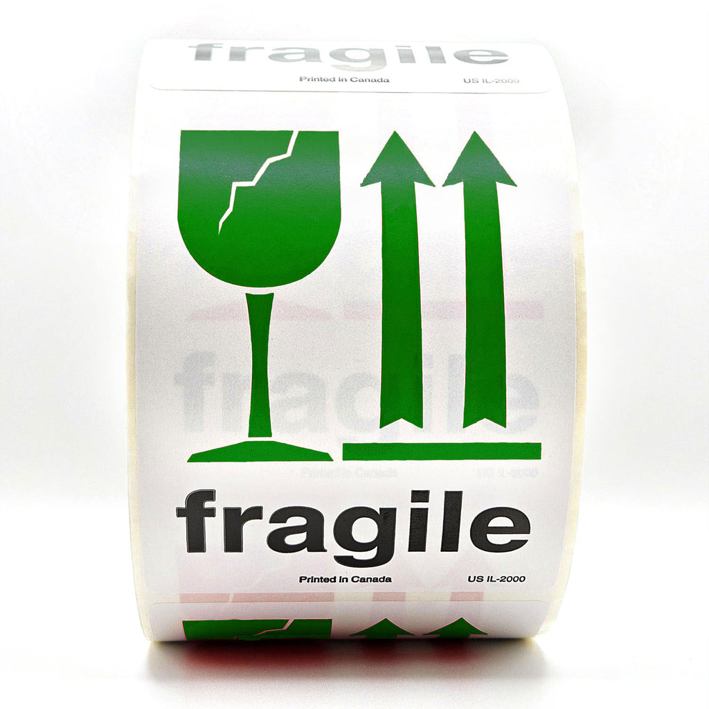 A roll of white shipping labels with 'Fragile' text and a green broken glass symbol, and arrows pointing up on it. Front view