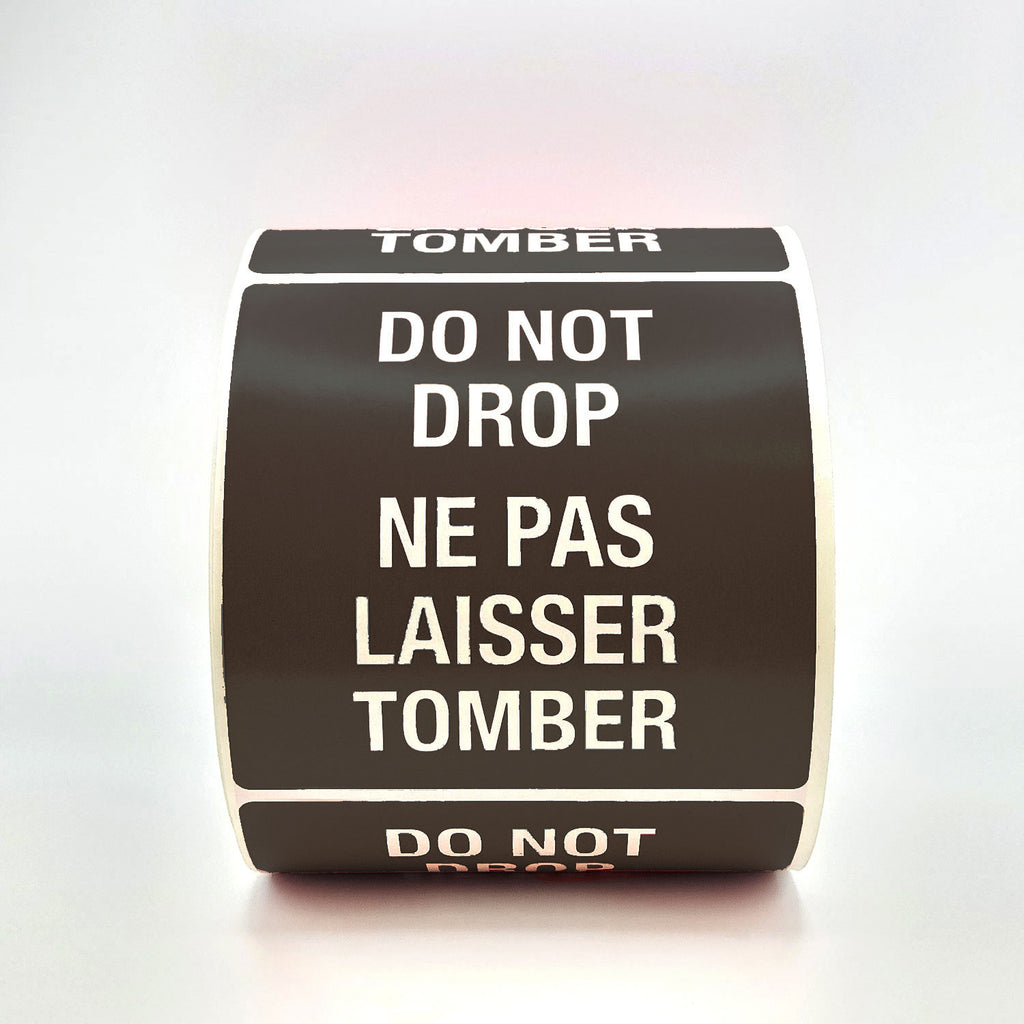 A roll of black labels with 'DO NOT DROP' text in both English and French, indicating the labels are bilingual.