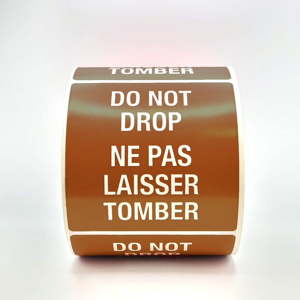 A roll of red labels with 'DO NOT DROP' text in both English and French, indicating the labels are bilingual.