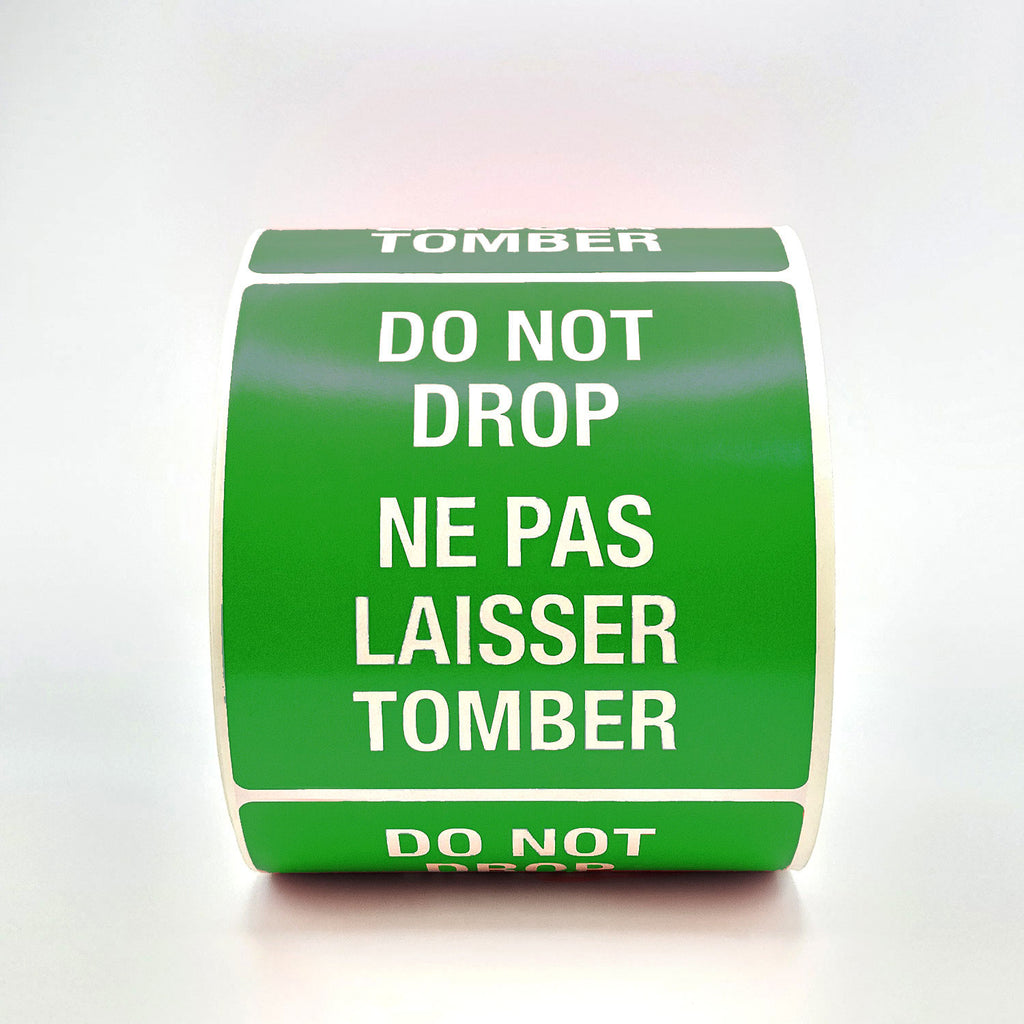 A roll of green labels with 'DO NOT DROP' text in both English and French, indicating the labels are bilingual.