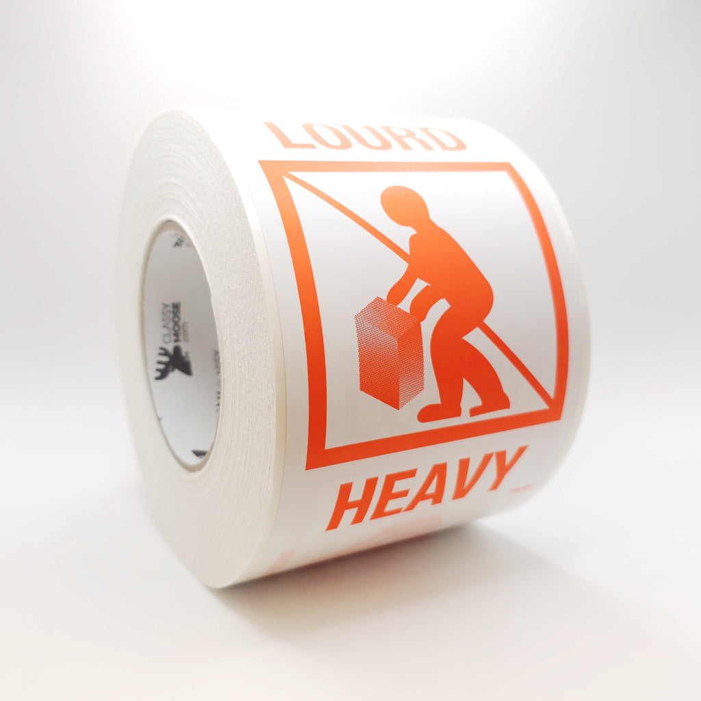 Roll of warning label with orange text and icon on a white background SIDE VIEW
