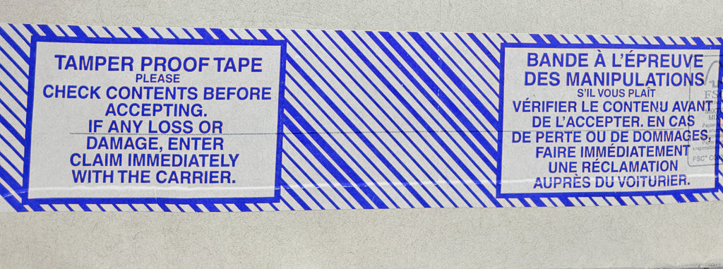A roll of tamper-proof packing tape with blue text and stripes on a white background, providing instructions to check contents before accepting and report any damage immediately.
