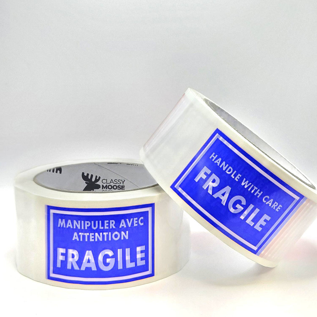 Two rolls of tape with blue 'Fragile' labels on a white background