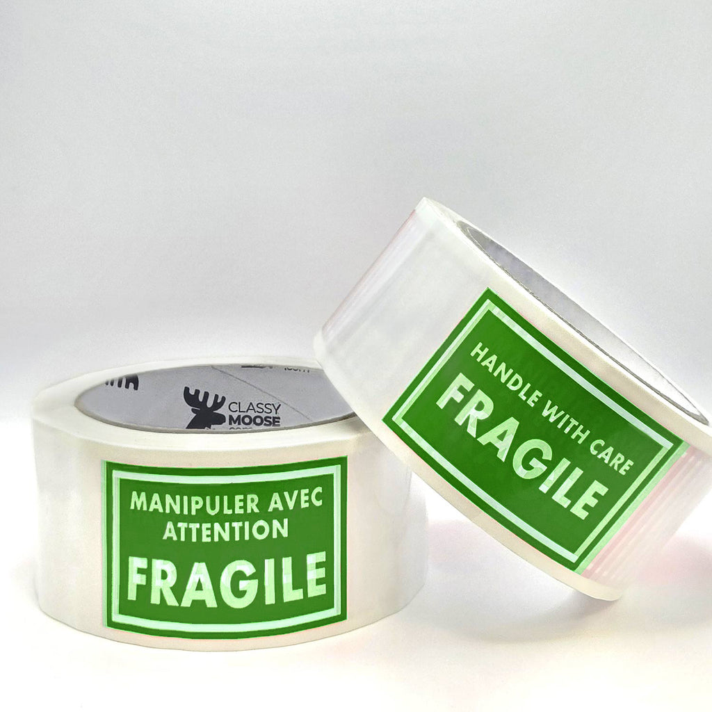 Two rolls of green tape with 'Fragile' labels on a white background