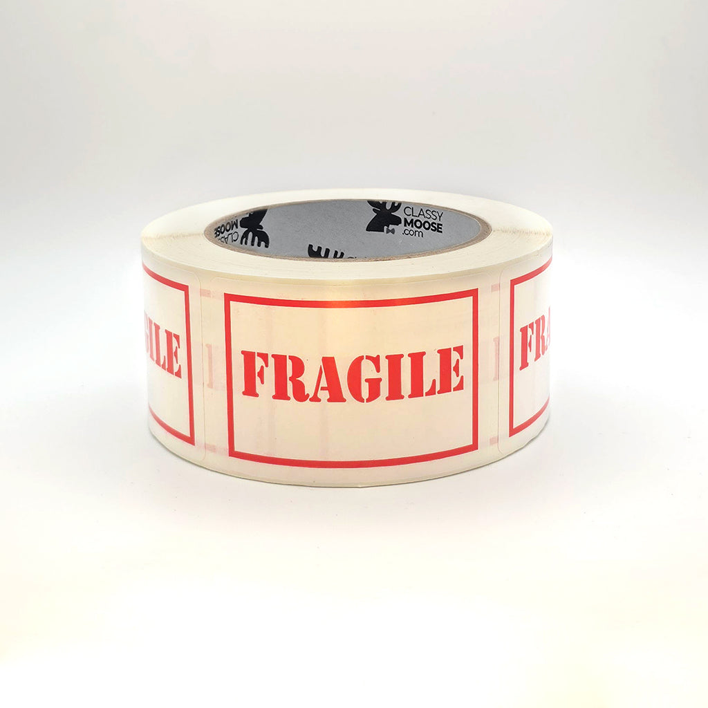 Roll of tape with 'Fragile' labels on a white background laying flat