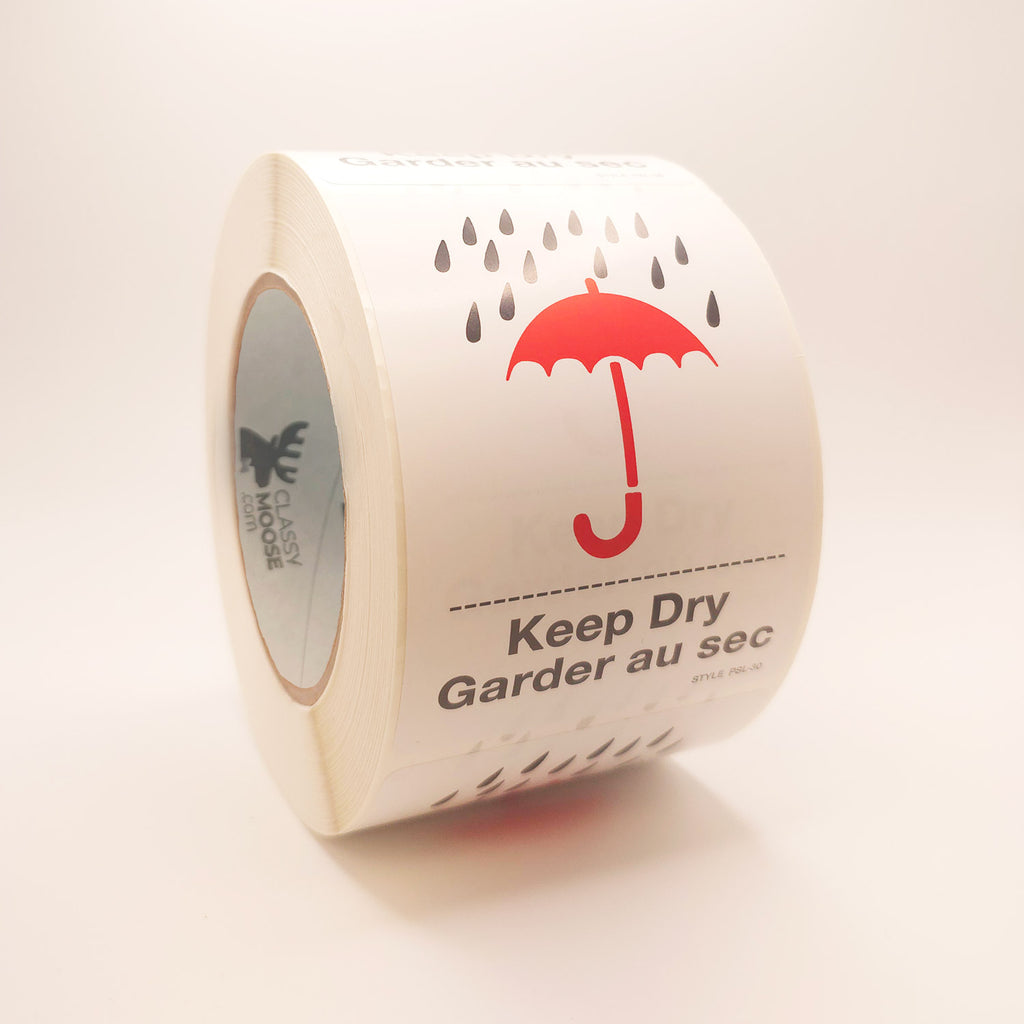 Roll of labels with a red umbrella and raindrop design, labeled 'Keep Dry'. side view