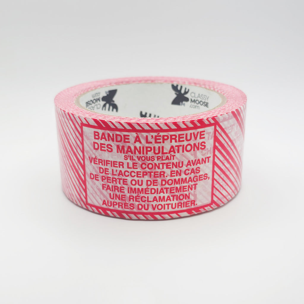 Roll of red and white tape with french text on a white background